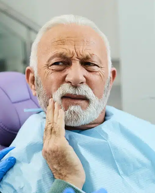 Senior patient talking with the dental team